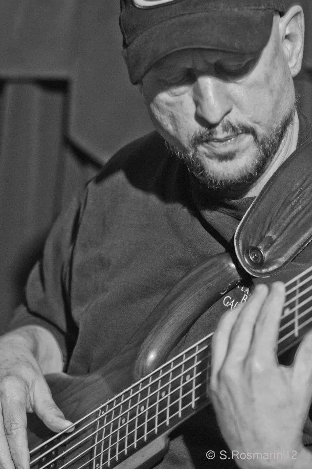 Black-and-white close-up of Russ Rodgers playing bass