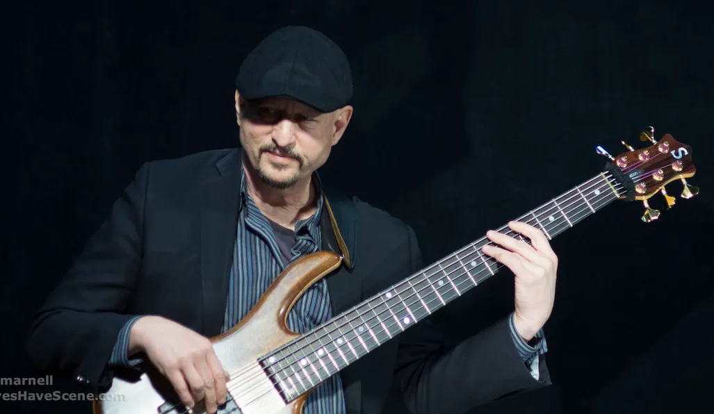 Russ Rodgers performing bass outdoors at a daytime festival